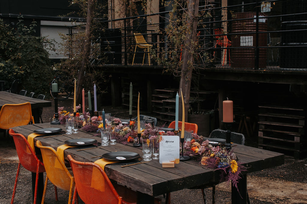 orange yellow and duck egg blue table scape at an urban french wedding location