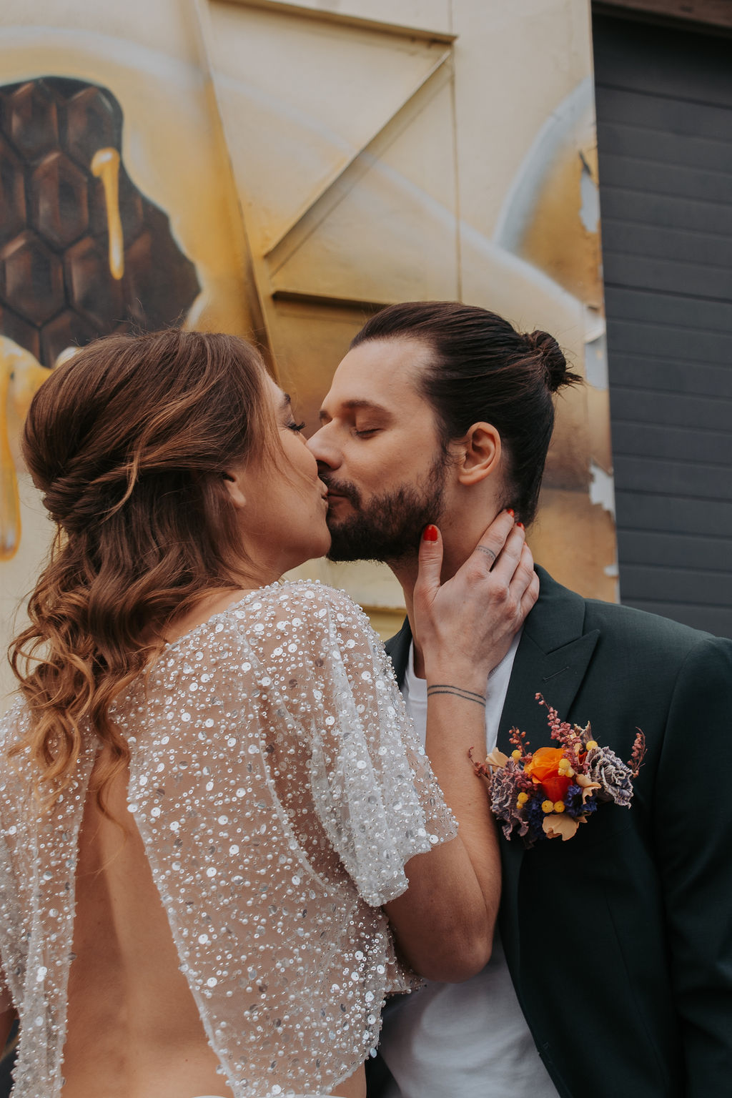 bride and groom share a kiss at french outdoor wedding