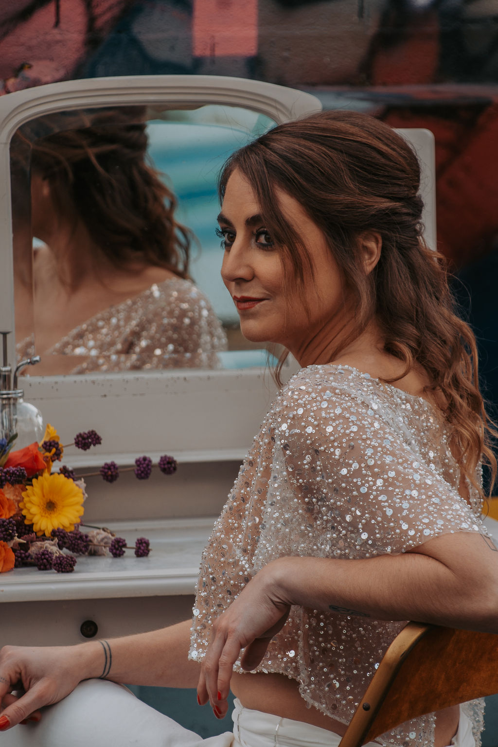 bride wears two piece wedding dress. bridal top is full of sequins