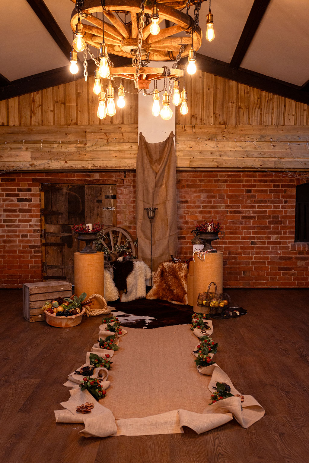 viking inspired wedding aisle dressed with natural hessian and produce