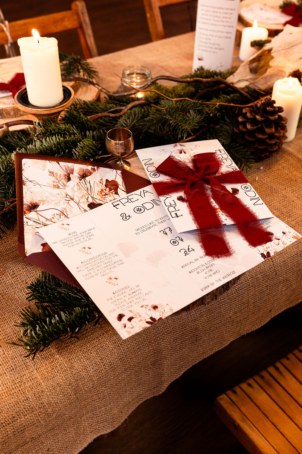 winter wedding inspired wedding stationery and table dressing. Blue spruce, chunky candles, wooden log slices and hessian decorate the long trestle table
