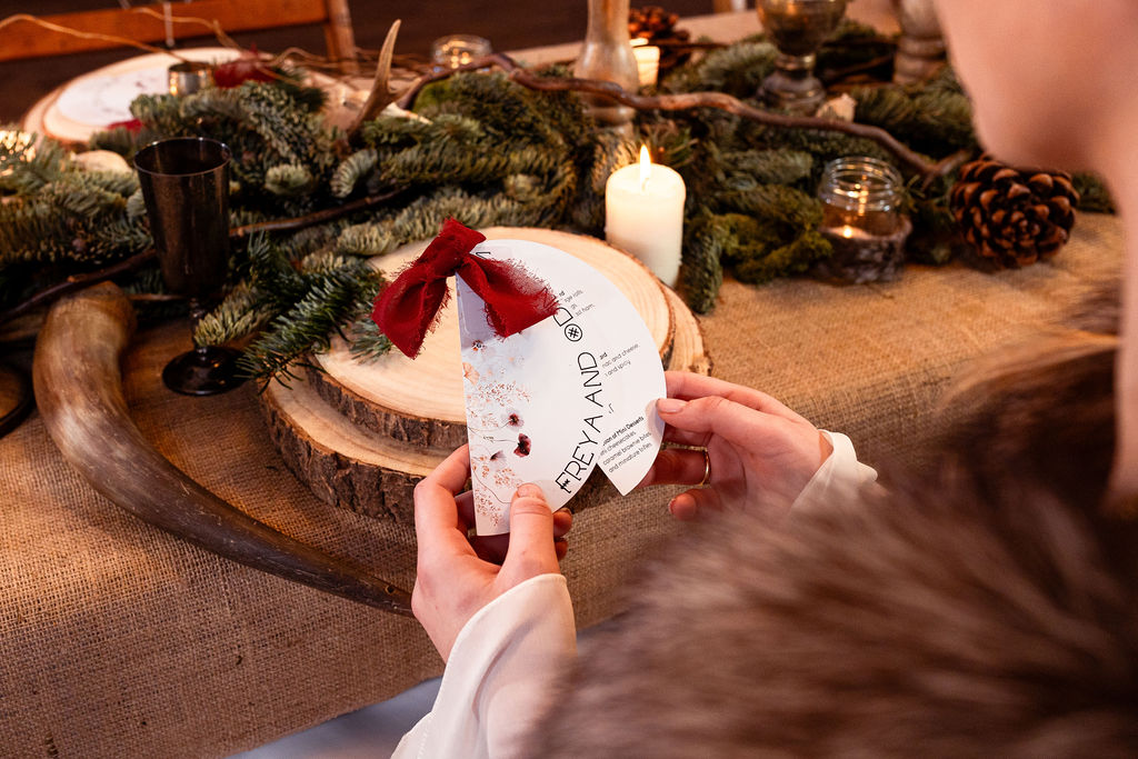 winter wedding inspired wedding stationery and table dressing. Blue spruce, chunky candles, wooden log slices and hessian decorate the long trestle table