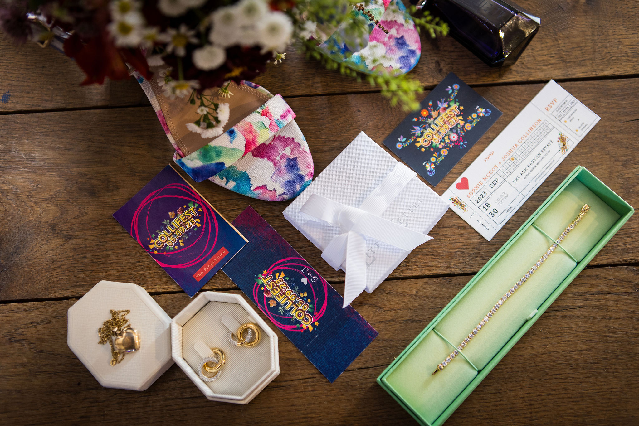 flat lay for festival themed wedding including festival ticket wedding invitations