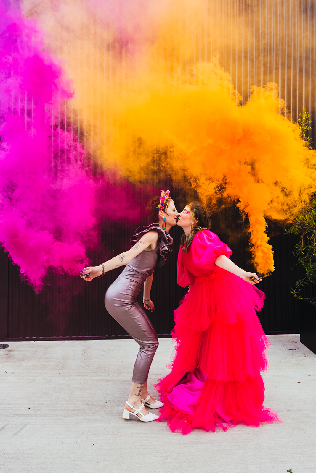 fun wedding photo with pink and orange smoke bombs
