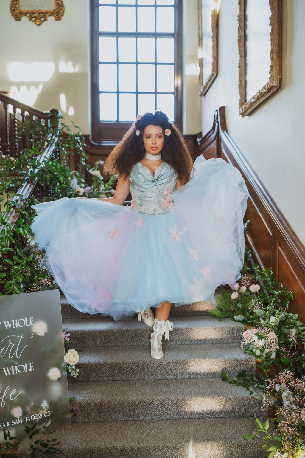bride in blue wedding dress walking downstairs