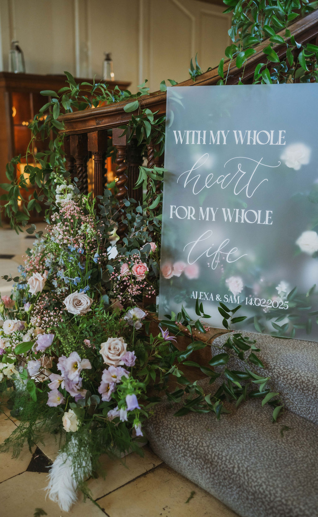 fogged glass wedding signage displayed with pastel flowers