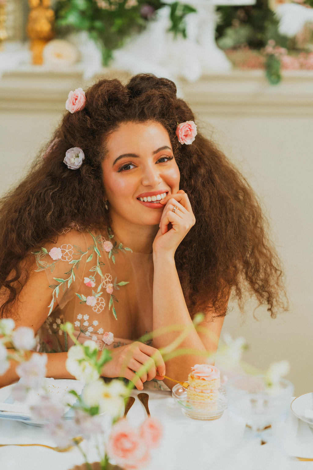 whimsical and romantic bridal hairstyle with flowers for curly hair