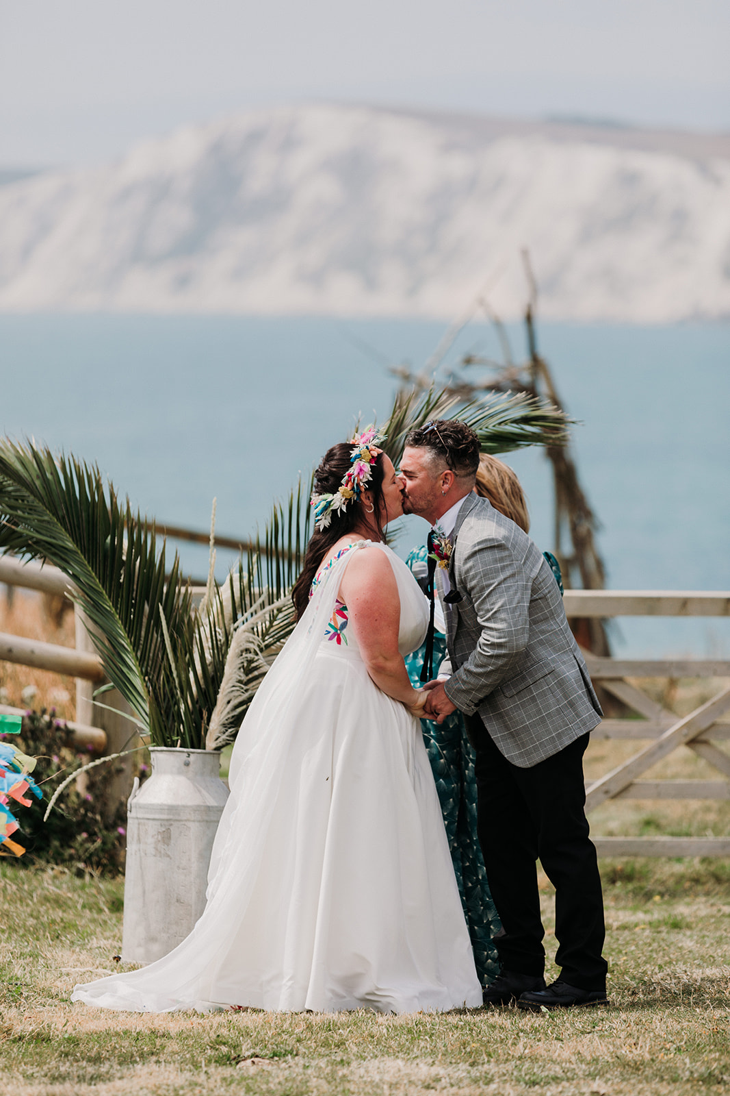 bride and groom share first kiss, outdoor wedding ceremony on the white cliffs of dover