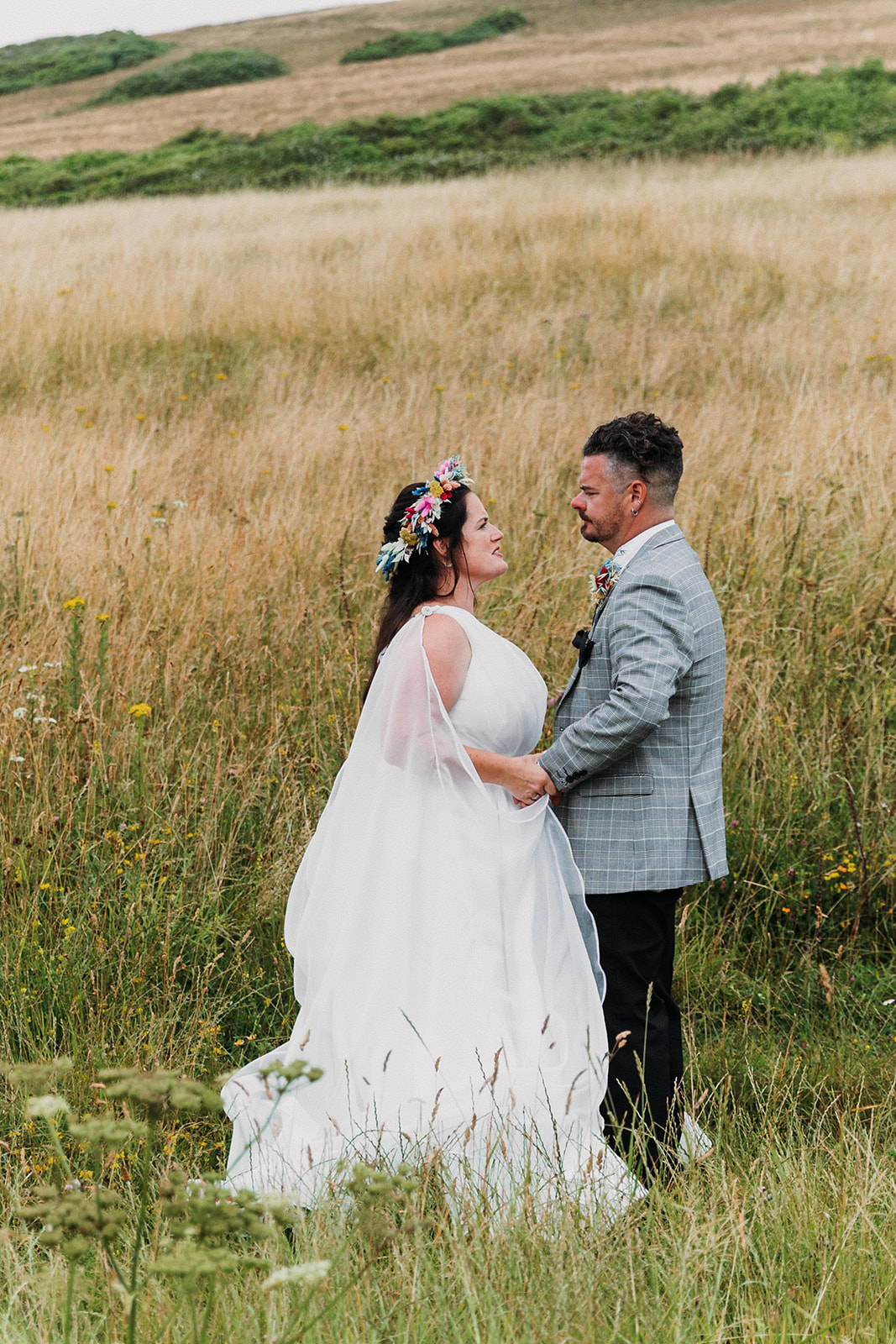 bride and groom stood on the cliffside, white cliffs of dover wedding, outdoor wedding ceremony, bride wears dried floral bridal crown and dried flower bridal bouquet