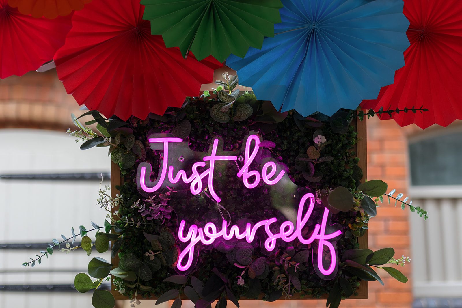 'just be yourself' pink neon sign