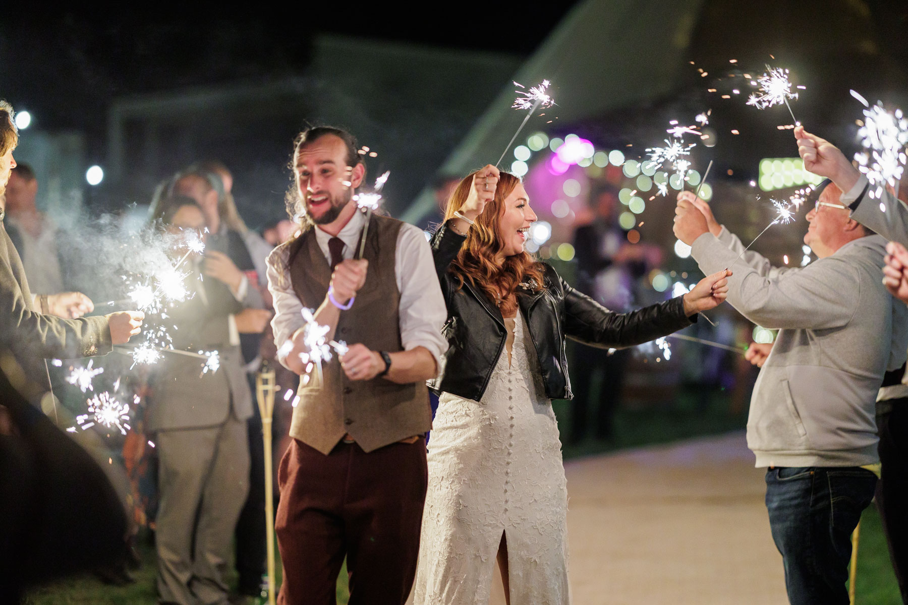 bride and groom smiing with sparklers