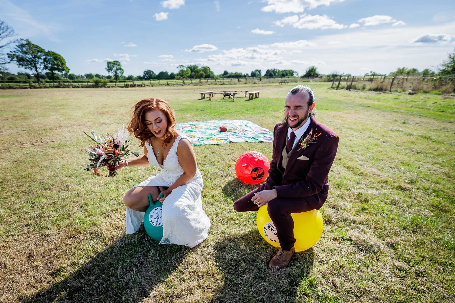 bride and groom on space hoppers - fun outdoor wedding photos