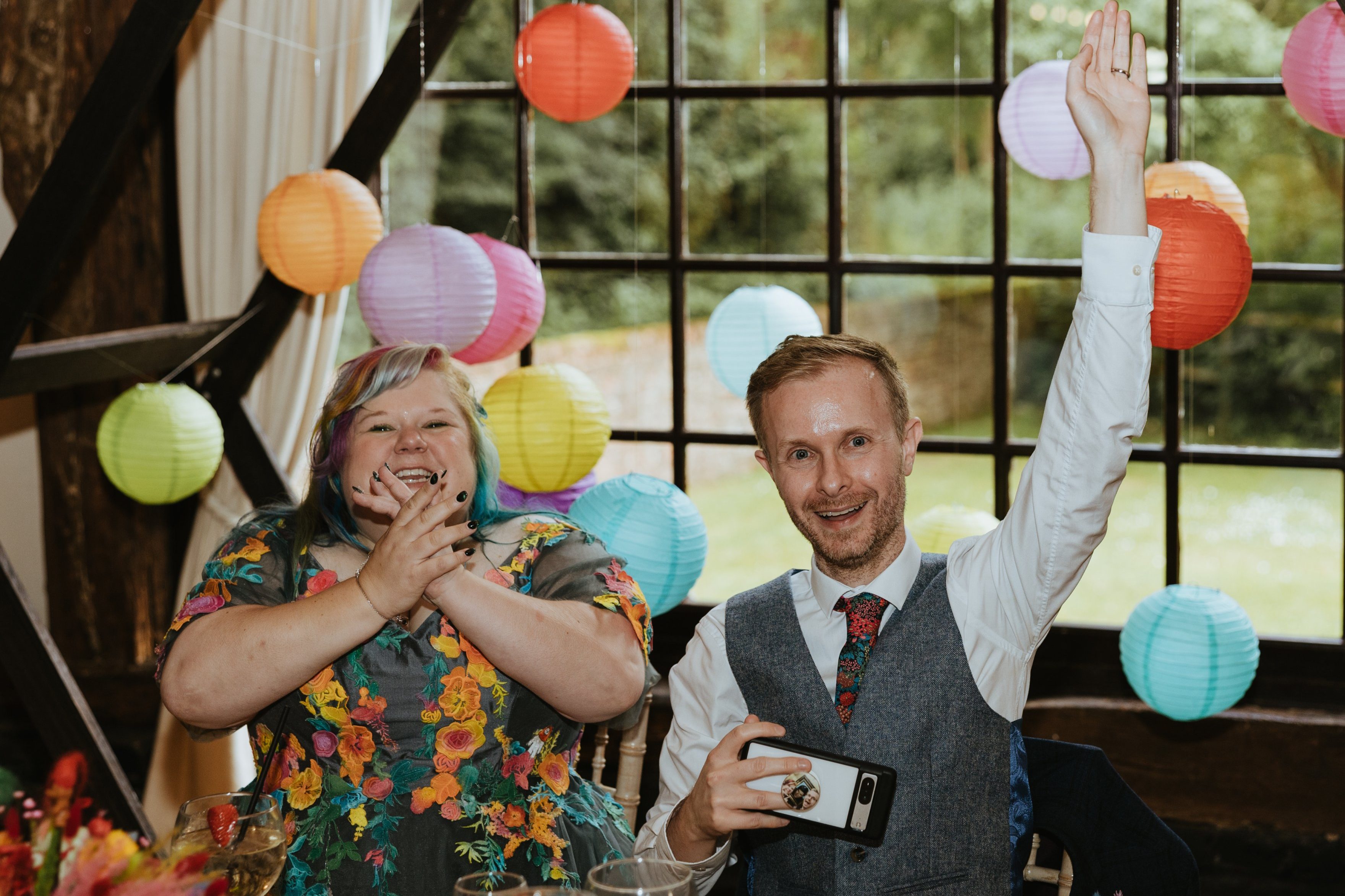 joyful wedding photo of bride and groom at colourful wedding