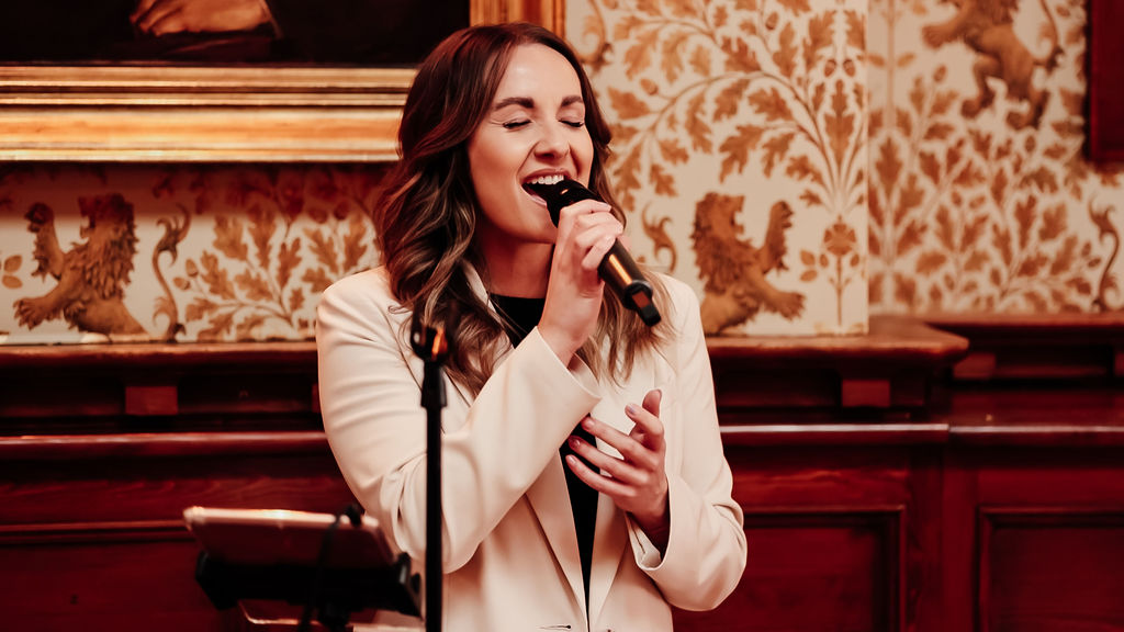 wedding singer wearing cream blazer