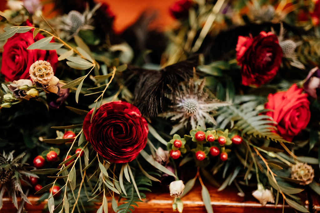 gothic wedding flowers with red roses and deep green foliage