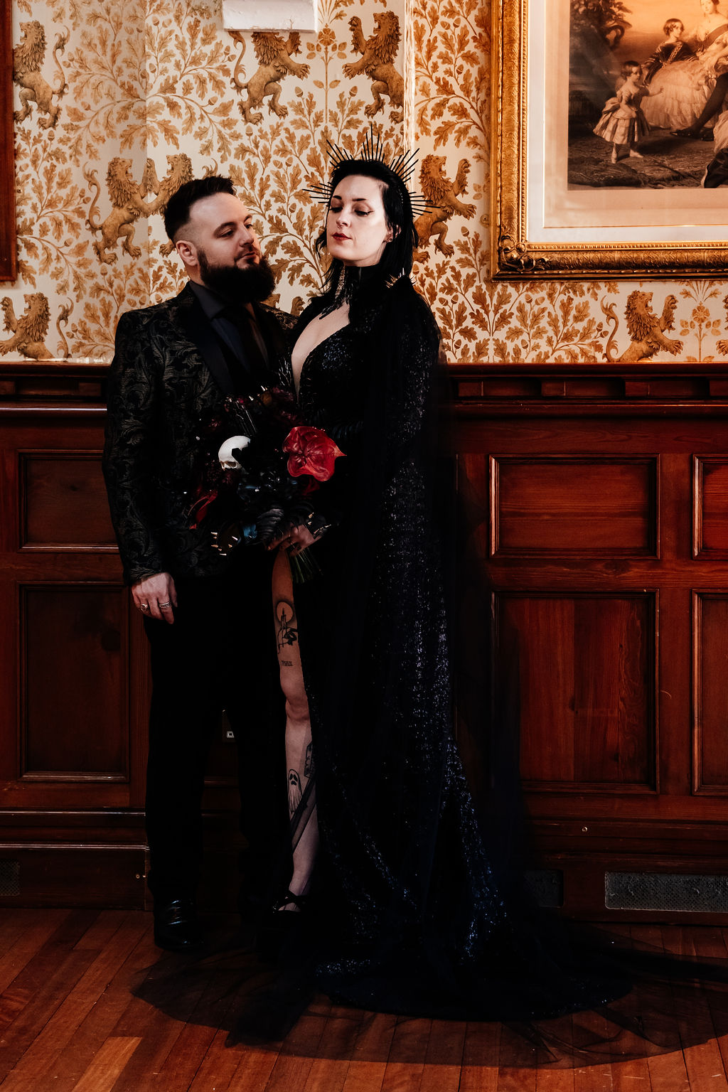gothic bride wearing black wedding dress and groom in gothic black suit