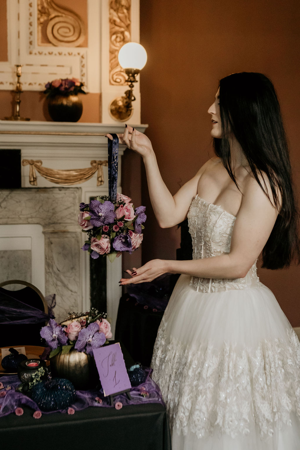 bride holding alternative wedding bouquet with purple and pink flowers