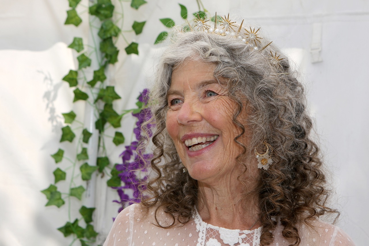 mature bride wearing a celestial bridal headpiece and floral earrings