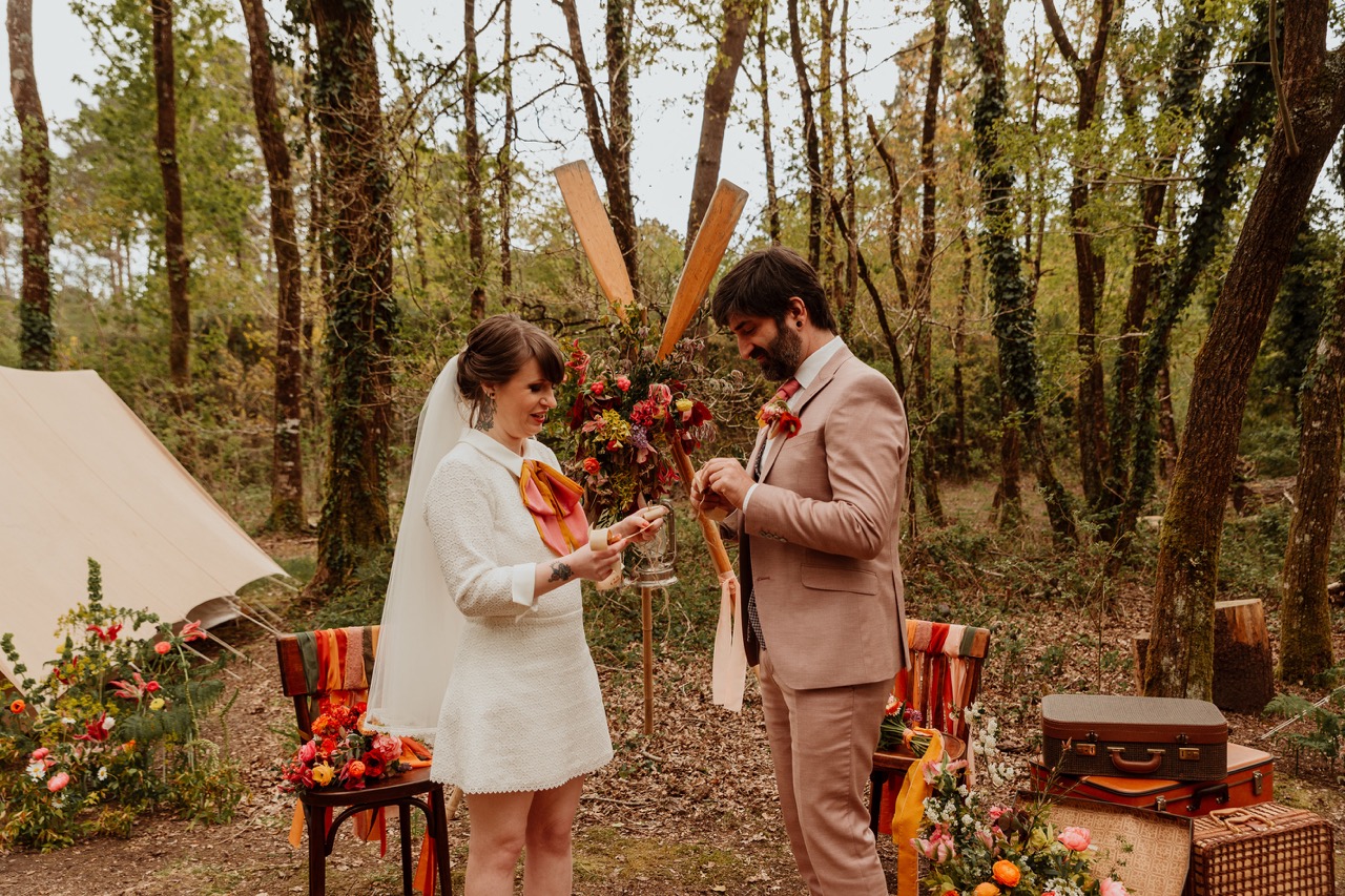 bride and groom exchange vows in woodland ceremony - wes anderson wedding theme