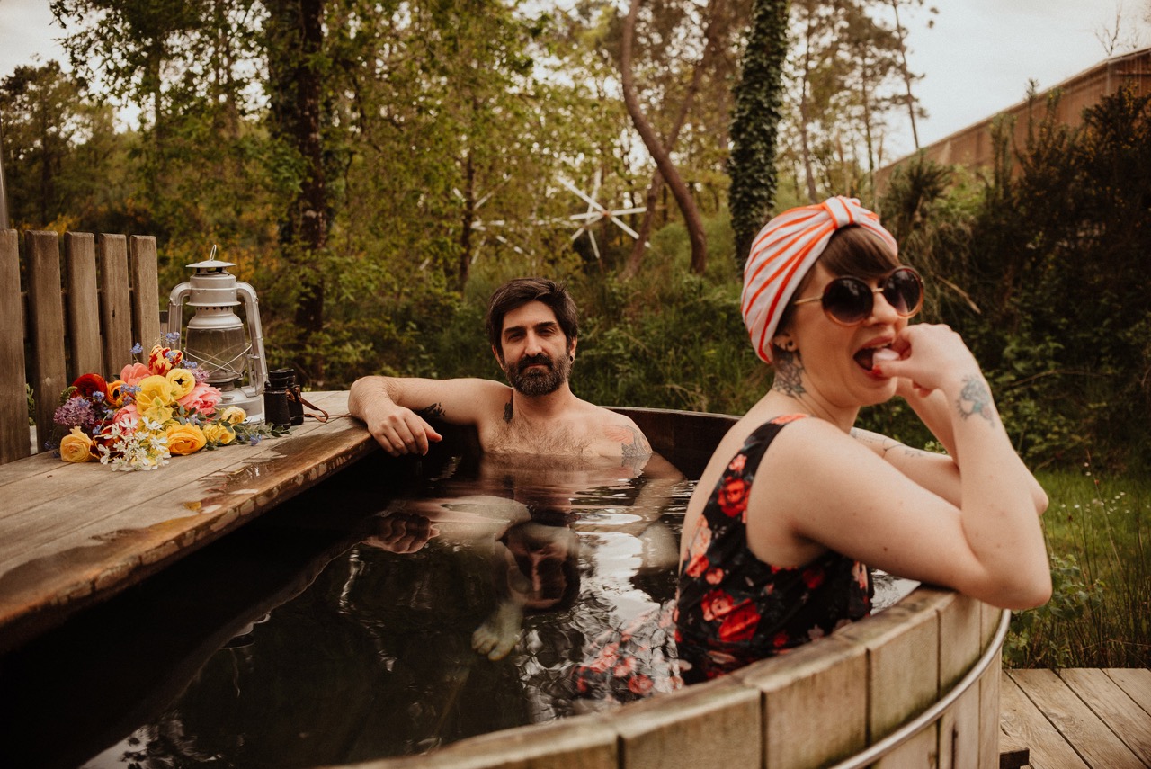 bride and groom in hottub at outdoor wedding