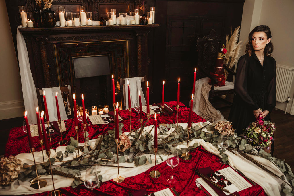 red wedding table styling with candles and foliage for gothic winter wedding