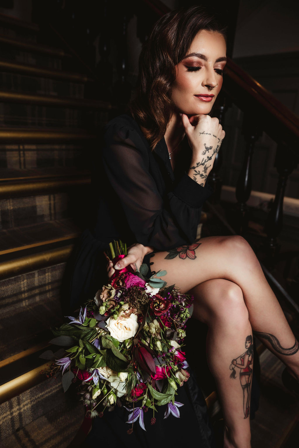 bride with tattoos wearing black wedding dress with leg slit