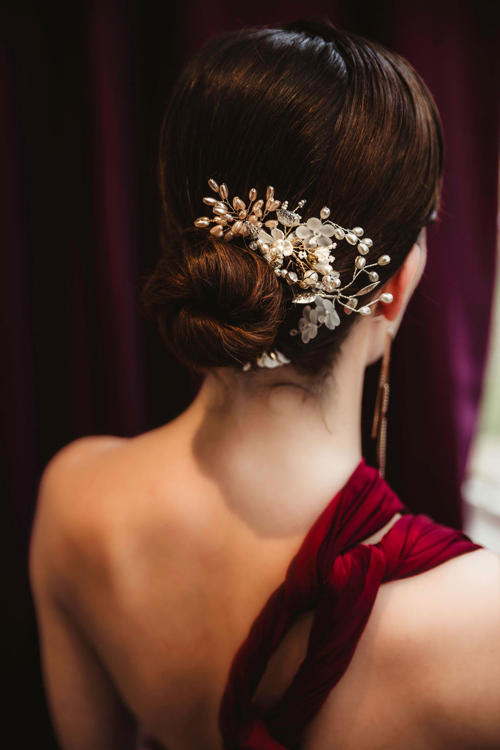 sleek bridal updo with white pearl hair piece