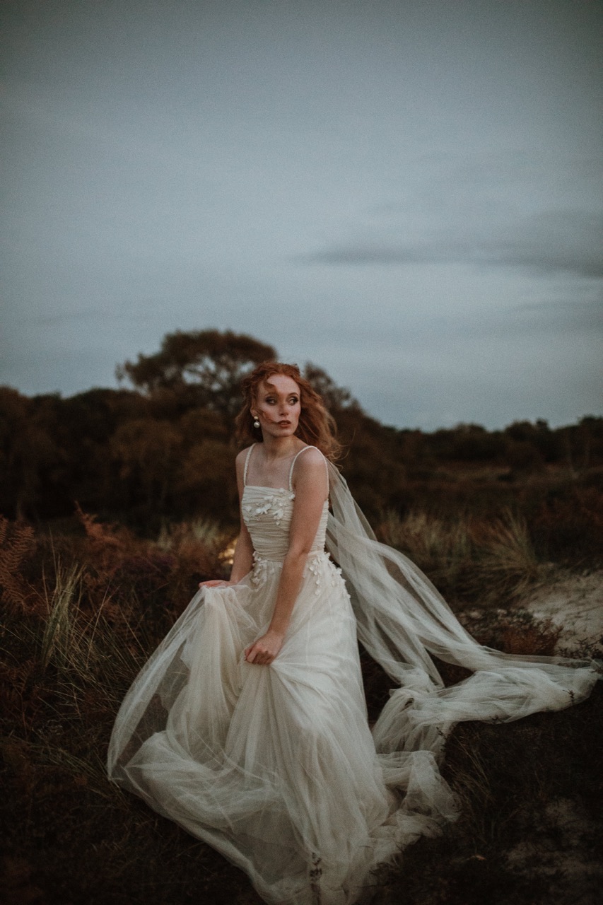 ethereal wedding photography of bride running through the wilderness