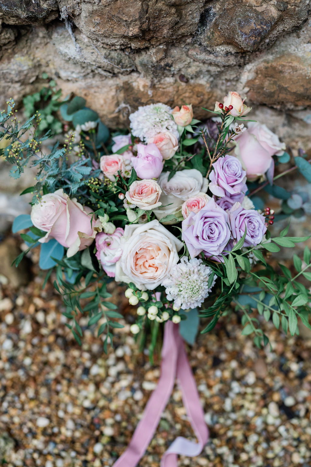 pastel rose wedding bouquet with pink and purple flowers