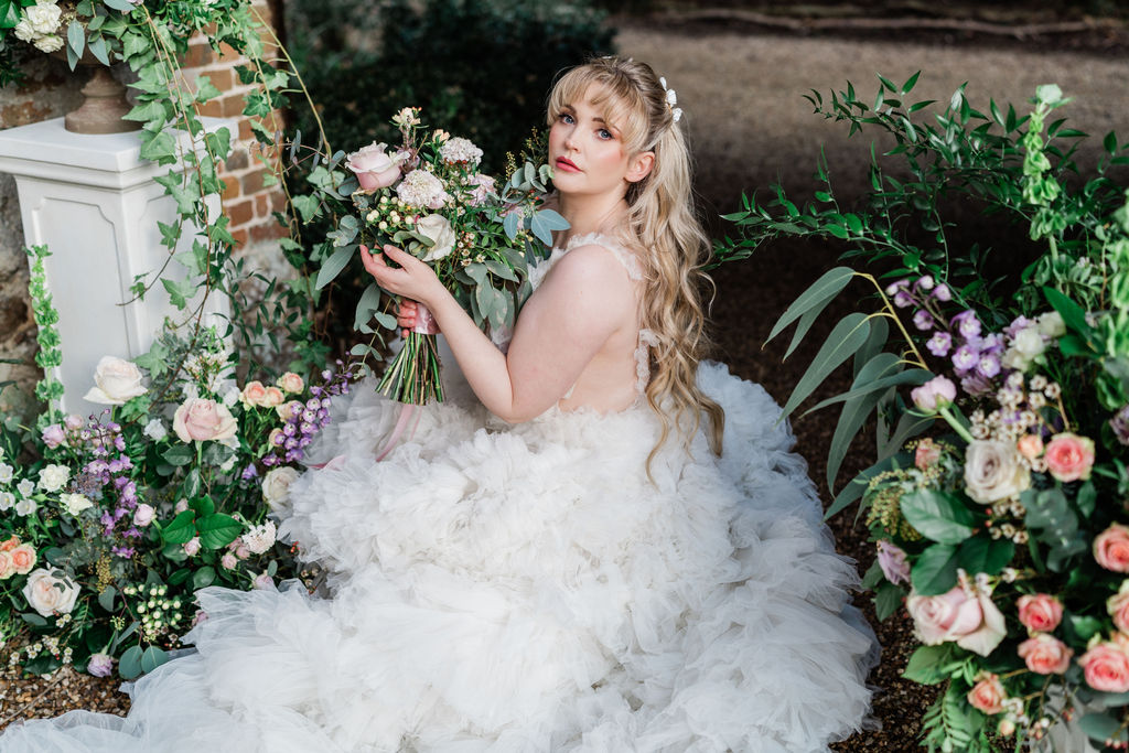 fairytale wedding photoshoot with white tulle wedding dress and pastel roses