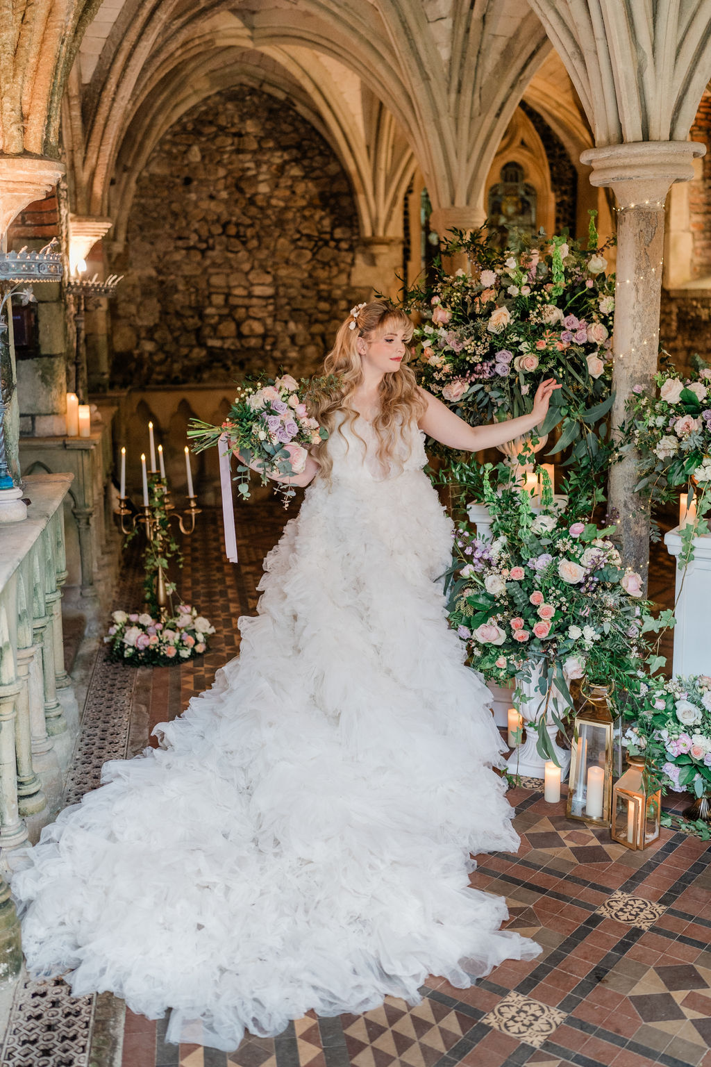 fairytale bride wearing long tulle wedding dress, in an ancient chapel