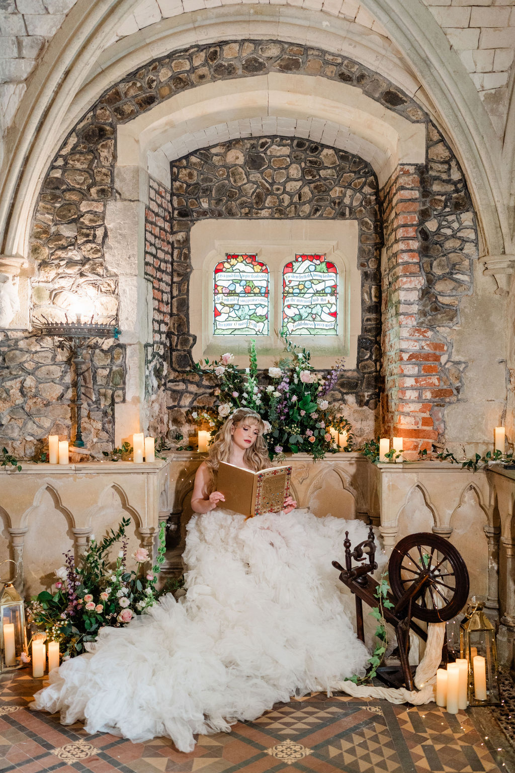 bride reading book at sleeping beauty inspired wedding on ancient chapel