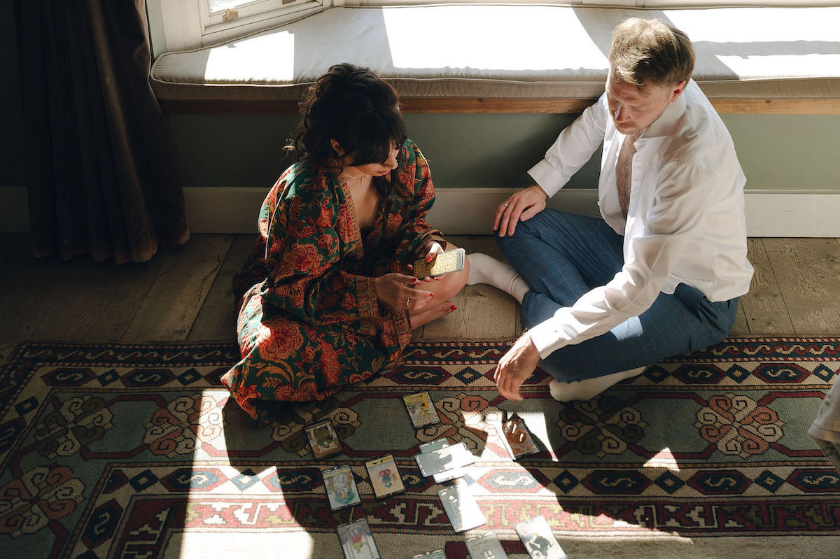 Bride and groom doing tarot cards the morning of there wedding