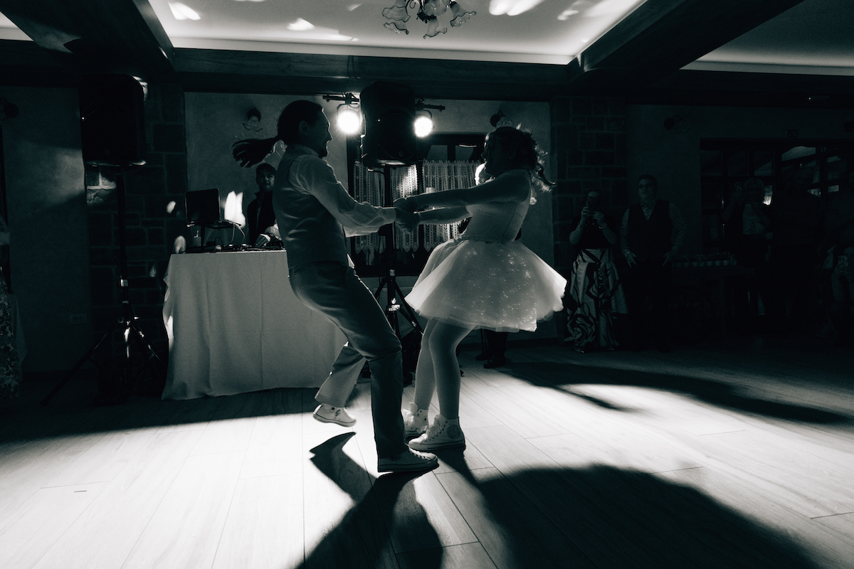 bride and groom dance wearing their hand painted converse trainers
