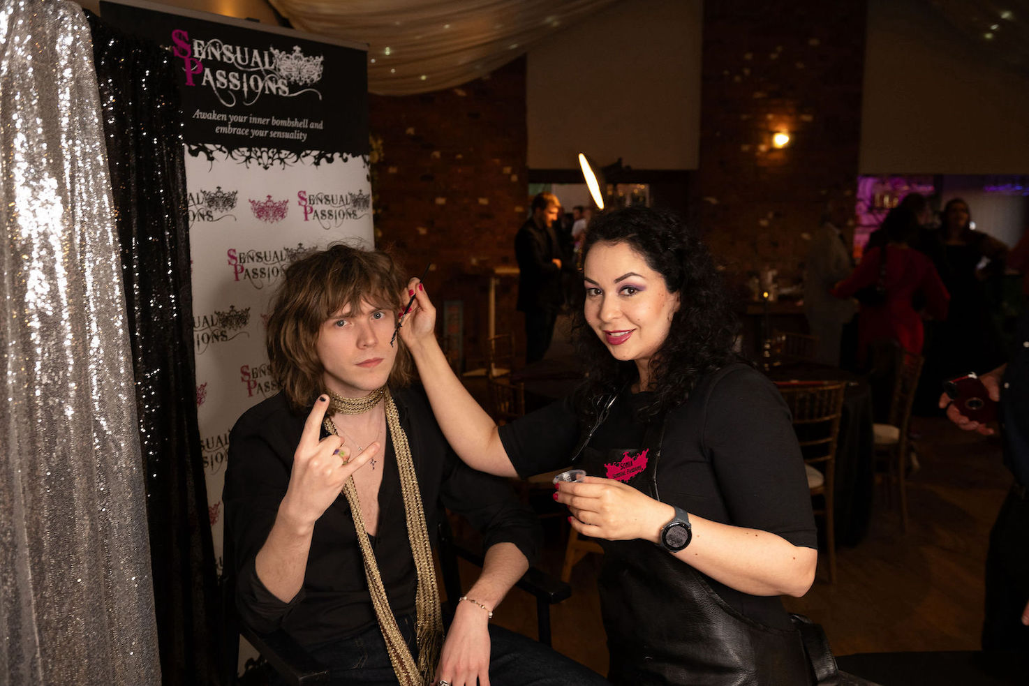 A wedding guest having glitter applied to their face for alternantive wedding evening party