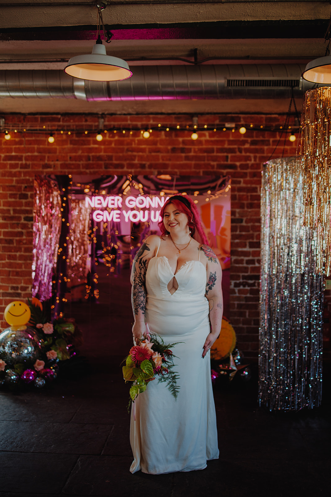 bride wearing peep hole two piece wedding outfit celebrates her individuality in front of tassel chandeliers