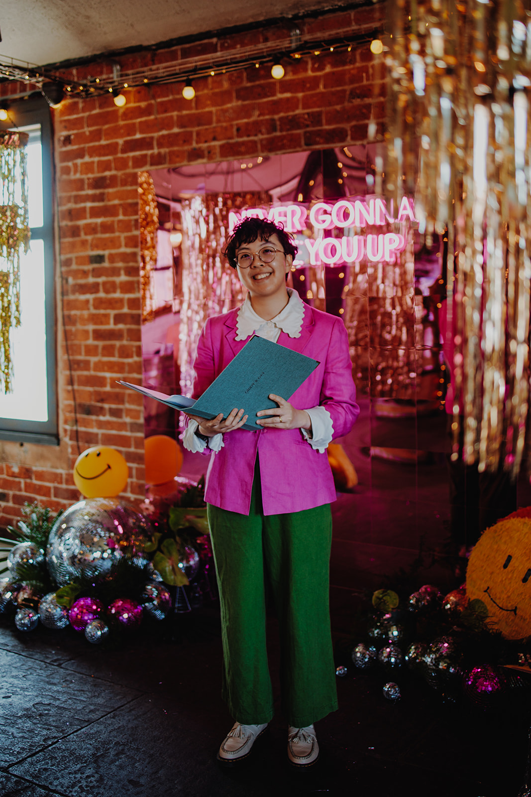 Wedding celebrant wearing pink and green to coordinate with the vibrant colour scheme of the wedding day.