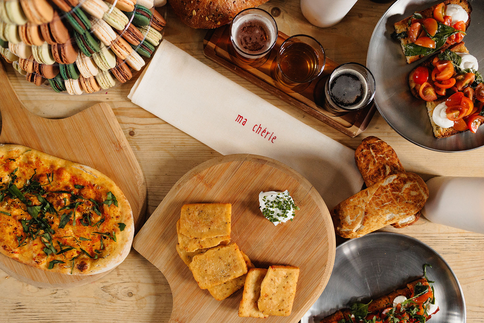 detail shot of embroidered napkin, breads and tasting cask ales for relaxed brewery wedding