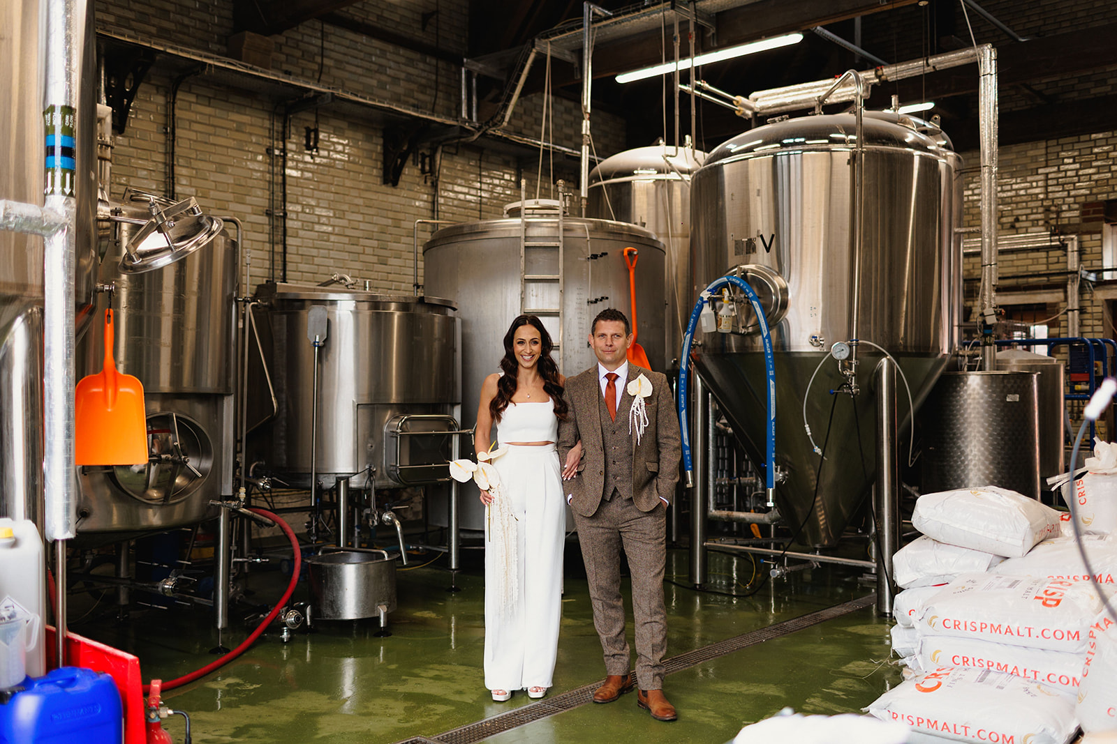 bride and groom wedding day portrait in the back of the brewery with the stills