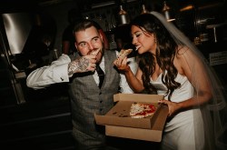 bride and groom eat pizza at their wedding from dough disciples pizza truck in york