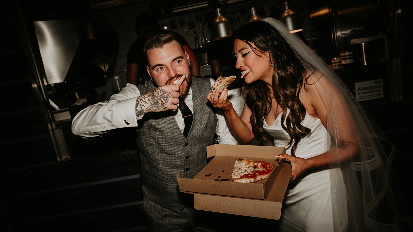 bride and groom eat pizza at their wedding from dough disciples pizza truck in york