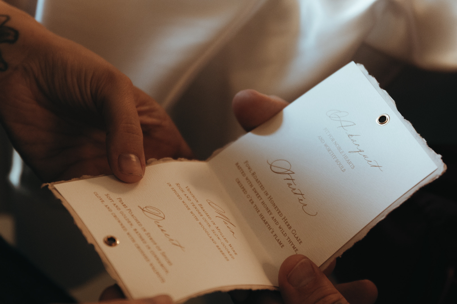 a fold out wedding breakfast menu with gothic script for castle wedding