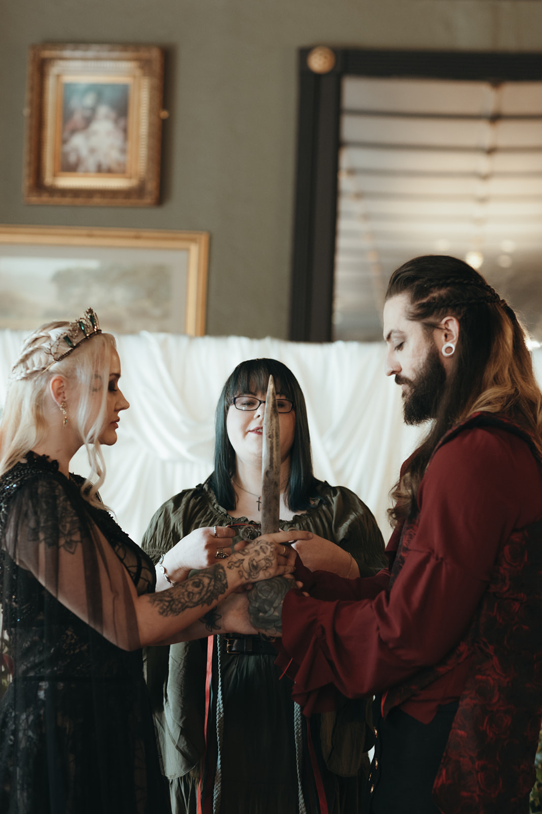 game of thrones inspired dressed bride and groom taking part in a sword ceremony for castle wedding