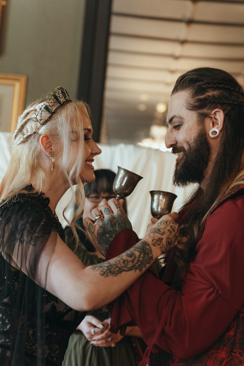bride and groom drink from goblets as part of gothic fantasy castle wedding ceremony