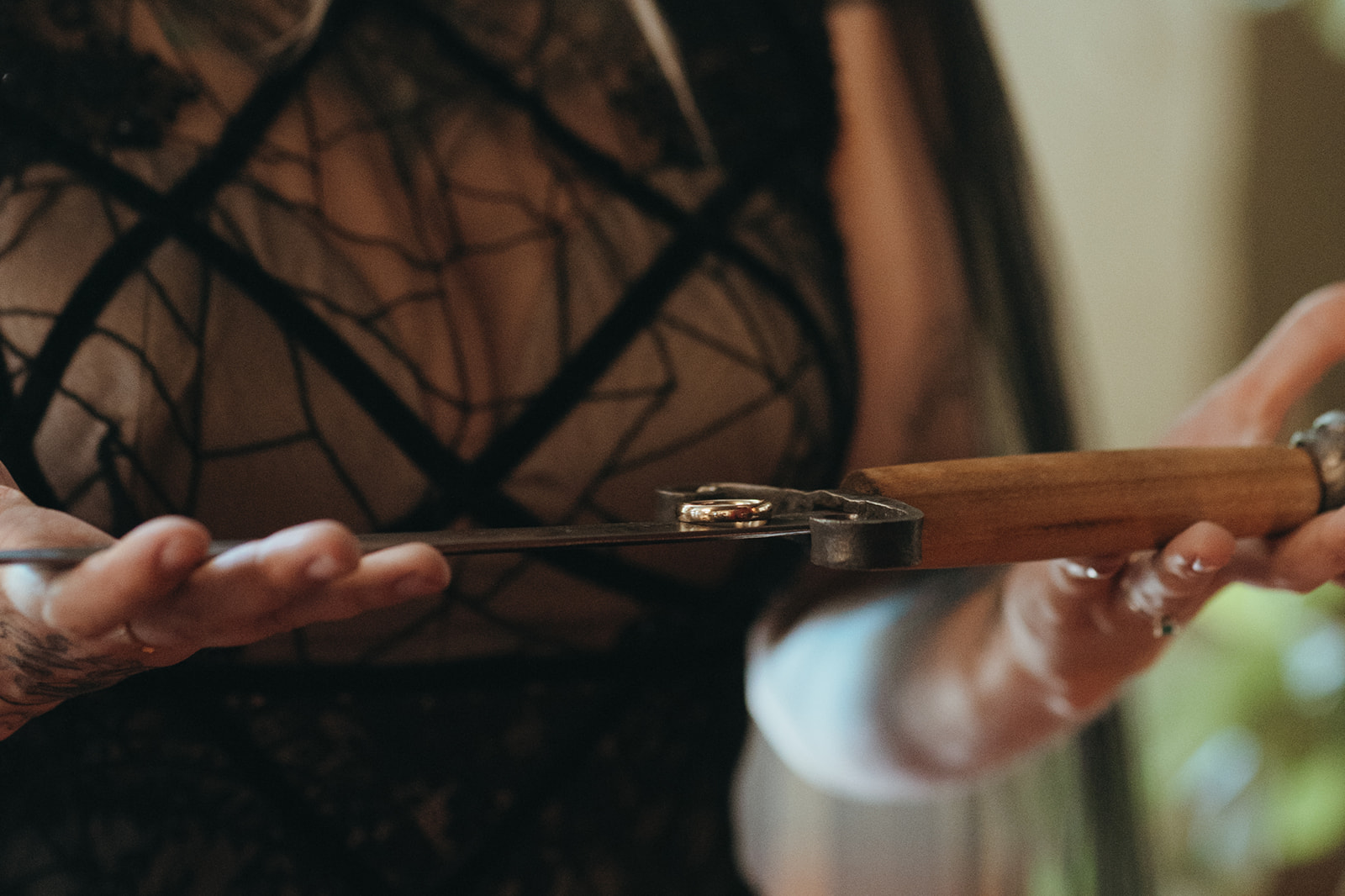 a wedding ring being presented on a sword