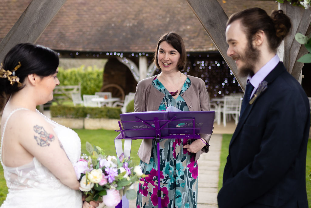 Accessible wedding planning - a bride and groom stand in front of a celebrant