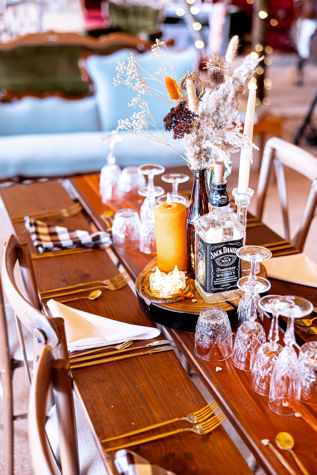 details of table styling for American dream western wedding with bourbon bottles and dried flowers