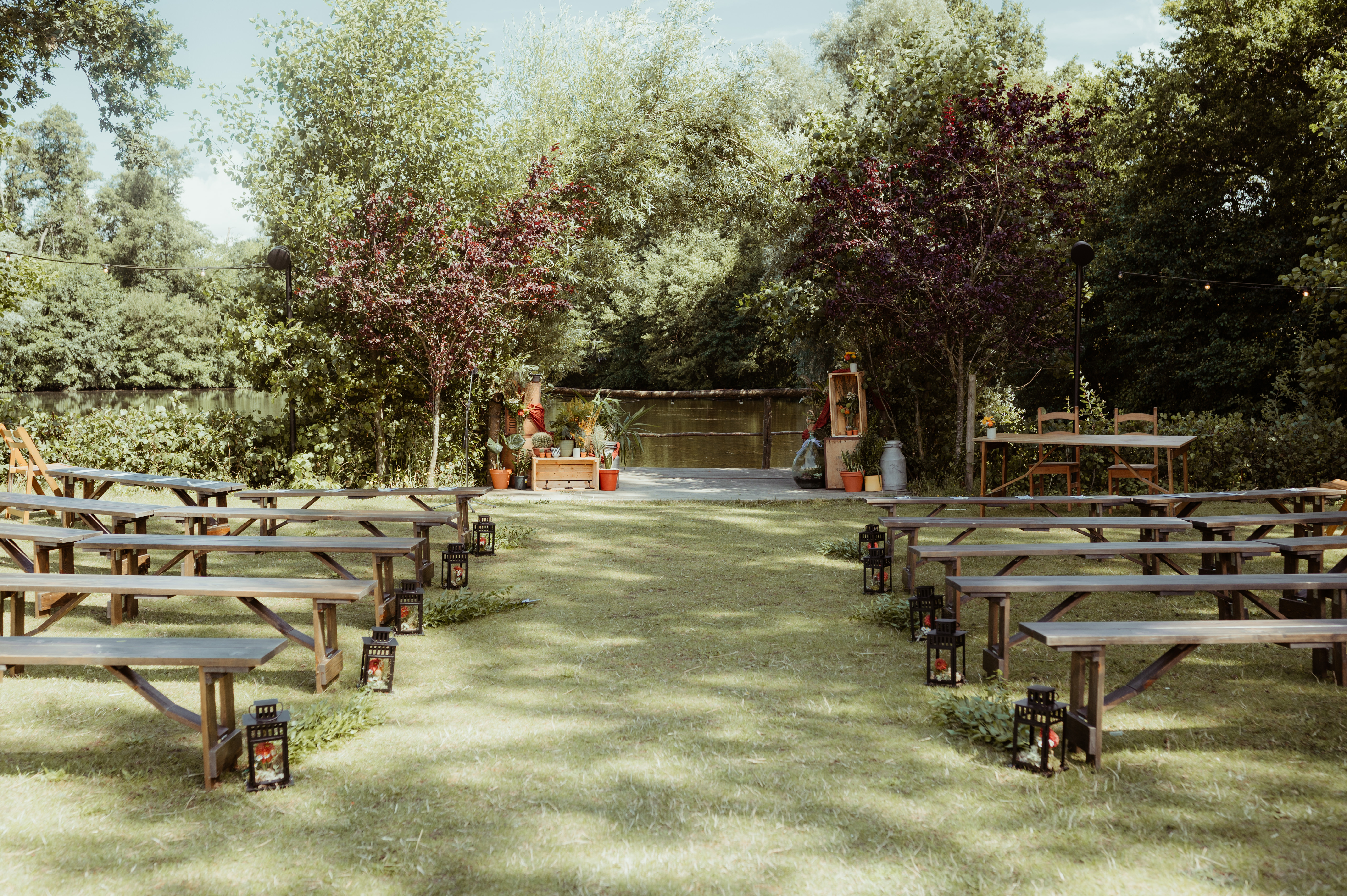 outdoor ceremony space with benches in front of a lake