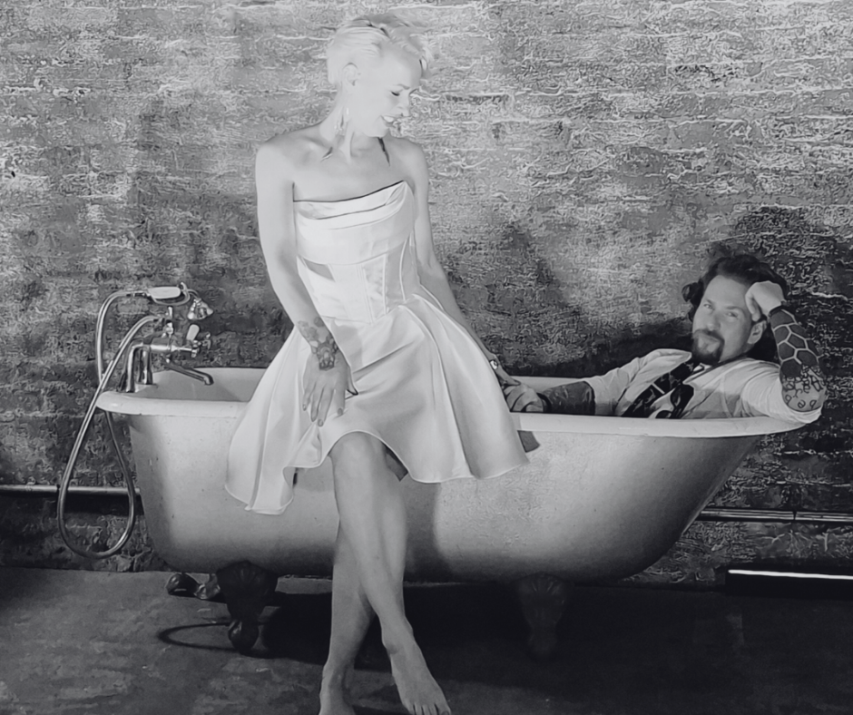 bride and groom pose in the bath tub. Wedding planned by Love Buzz Weddings