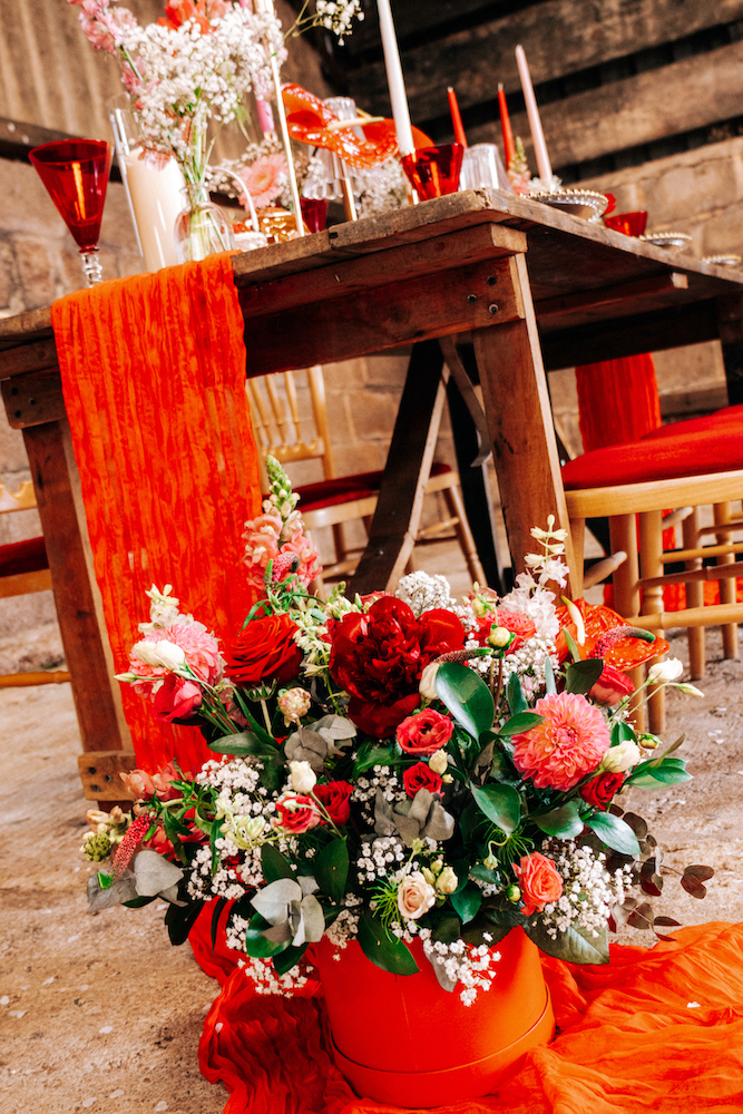 detail shot of flower arrangement at the end of wooden breakfast table